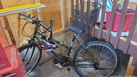 Full side view of the ladies bicycle showing black frame, basket, helmet, and tires.