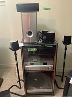 Full view of Pioneer surround sound system components including speakers, receiver, disc player, and cabinet.