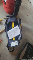 Carrying case with manual visible inside, tool not shown.