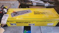 Original boxed tile cutting machine NO.SC-2, showing model and cutting capacity on yellow box with product images.