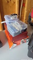 Stacked plastic case with sanding drums, polishing bits, and packed boxed tools below
