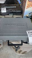 Closed view of gray molded plastic carrying case with Coleman branding and handle.