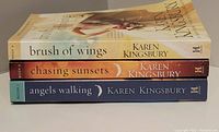 Stacked spines of the three books showing titles and author.