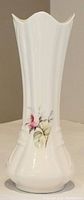 Full view of the vintage white Irish Parian china bud vase with tapered scalloped rim and embossed detailing at base.