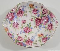 Top view of the Victorian Rose candy/trinket dish showing intricate floral pattern and gold-edged scalloped rim with two small handles.