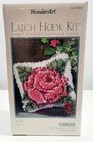 Front of the sealed Wonder Art latch hook kit box showing the rose pillow design and brand information.