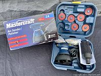 Mastercraft Arc Sander/Polisher kit with 7 sanding pads in molded case, dust collection attachment, original box visible.