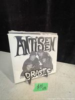Photo showing the 45 RPM record sleeve for Antisen's 'The Drastics EP' with band photo and logo