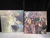 Photo of two vintage punk rock vinyl records side by side, with the 'Cobra Noir' album on the left and the 'MC5' album on the right, showing wear on covers.