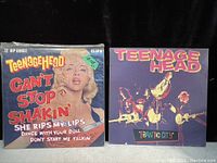 Photo showing the front covers of two Teenage Head vinyl records: a 12-inch single 'Can't Stop Shakin'' with a colorful graphic cover, and the LP 'Frantic City' featuring a photo of the band.
