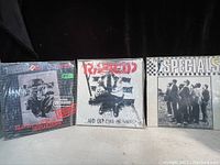 Front view of the three vinyl records by The 101ers, Rancid, and The Specials with visible album artwork.