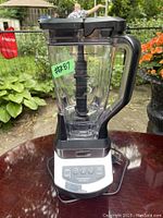 Front view of the new Ninja Professional blender showing clear container with measurement marks, black handle, and control panel on base.