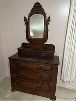 Full view of antique Victorian dresser showing mirror, top small drawers, and overall structure