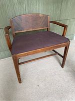 Full view of the wooden Art Deco vanity bench with brown cushioned seat and waterfall style wooden backrest.