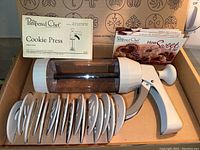 Pampered Chef Cookie Press with 10 decorative discs, recipe cards, and original box.