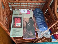 Photo of all three pairs of gloves together in a basket showing packaging and condition.