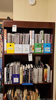 Full bookshelf showing comic storage boxes and books
