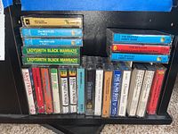 Photo of assorted cassette tape collection with visible titles and artists