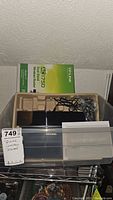 Wireless router TP-Link AC1750 model with power adapter and original box in foam tray, unopened box behind.
