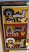 Full view of the rectangular weaving showing three horizontal panels each with a traditional Andean figure against different color backgrounds.