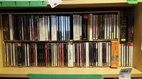 Shelf view showing two rows of opera CDs in jewel cases