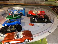 Overview photo of ten model cars on display, various brands, scales, and colors, some boxed, some loose.