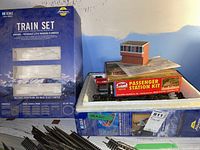 Styrofoam tray with empty Athearn HO Scale Train Set box, Atlas Passenger Station Kit box and assorted track sections