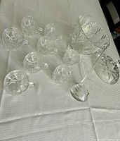 Full set on table showing punch bowl, 8 matching cups, lid off to the side, and ladle laid out