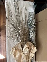 Image showing the full arrangement of various artificial floral stems including white berry branches, gold glitter twigs, and white flower sticks with leaves.