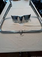 Chrome engine guard with tubular design and mounting points on table.