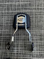 Front view of Harley Davidson Fatboy detachable sissy bar with black leather backrest and chrome mounting hardware