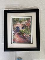Front view of the framed lithograph featuring a garden pathway scene.