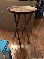 Full view of the wooden tray table with metal stand, showing the entire item and its structure.