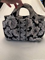 Front view of the Vera Bradley small tote showing the black and white Camellia floral pattern and two handles.