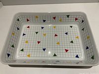 Top-down view of the large rectangular serving platter showing colorful triangular pattern on a grid background.