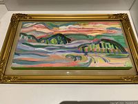 Full view of the framed oil painting signed by Elizabeth Greisman featuring abstract landscape in vibrant colors.