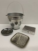 Photo showing the bucket, round dish, square tray, and textured lid trinket box