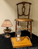 Photo showing the full set with side chair, electric lamp with shade, traditional glass kerosene lamp, and wooden tray on black surface.