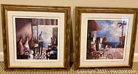 Two framed 19 inch square beach cafe themed prints, side by side on a wall. Both prints are matted and framed in gold-tone distressed frames.