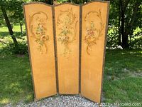 Full front view of the 3-panel folding screen outdoors showing painted floral designs and the overall condition of the panels