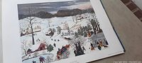 Photo of a winter village scene print by Grandma Moses showing people, houses, trees with snow.