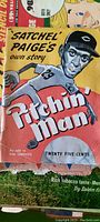 Cover of the story book showing illustrated caricature of Satchel Paige pitching with title 'Pitchin Man'