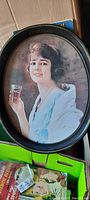 Full view of vintage oval tin Coca-Cola serving tray with woman holding Coca-Cola glass image.