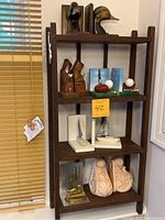 Full view of shelf with 5 sets of bookends and 2 single bookends arranged.