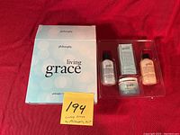 Box with Philosophy Living Grace body care small kit packaging and products in clear tray