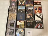 Full layout of 18 classic rock CDs showing various album covers from classic rock bands.