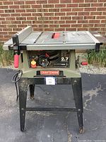 Front view of Craftsman table saw, showing motor power label, adjustment wheel, and brand plate.