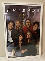 Photo front view of IKEA Ribba white frame with Friends poster inside showing main TV show cast.