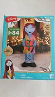 Box of Sally inflatable showing front printed graphics, Disney and NBC branding, states 5 ft tall, energy efficient LED, 1 piece inflatable.