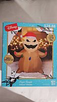 Box of Disney Oogie Boogie Airblown Inflatable with dimensions and specs visible, showing 3.5 ft height and LED lighting feature.